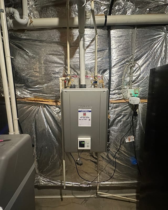 Tankless water heater and PEX supply lines in a utility space